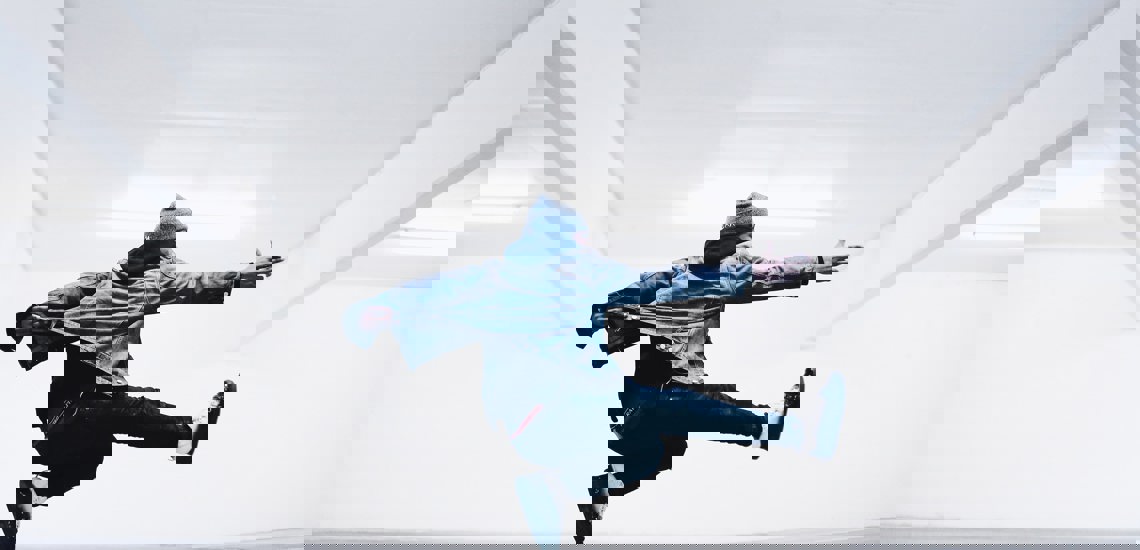 Boy jumping and pointing forward